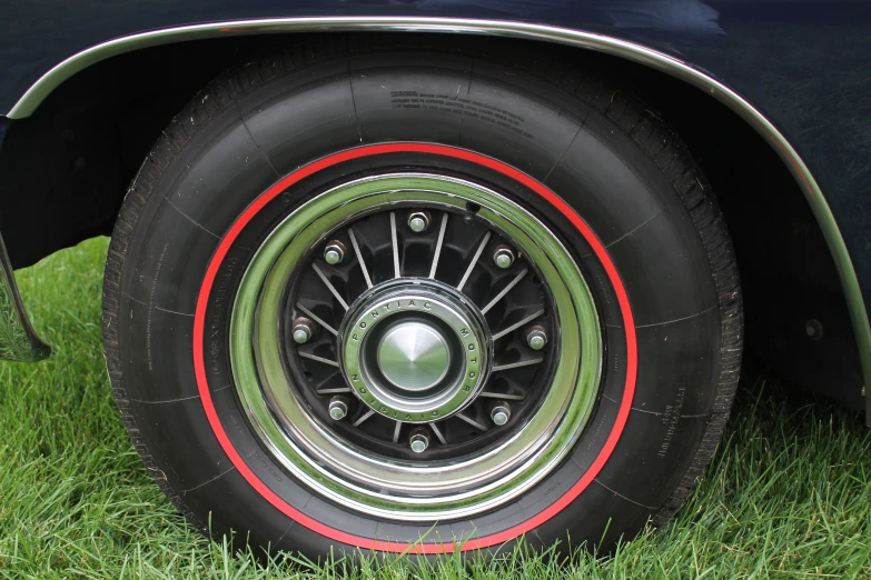 a closeup of the spokes on the tire of a classic car