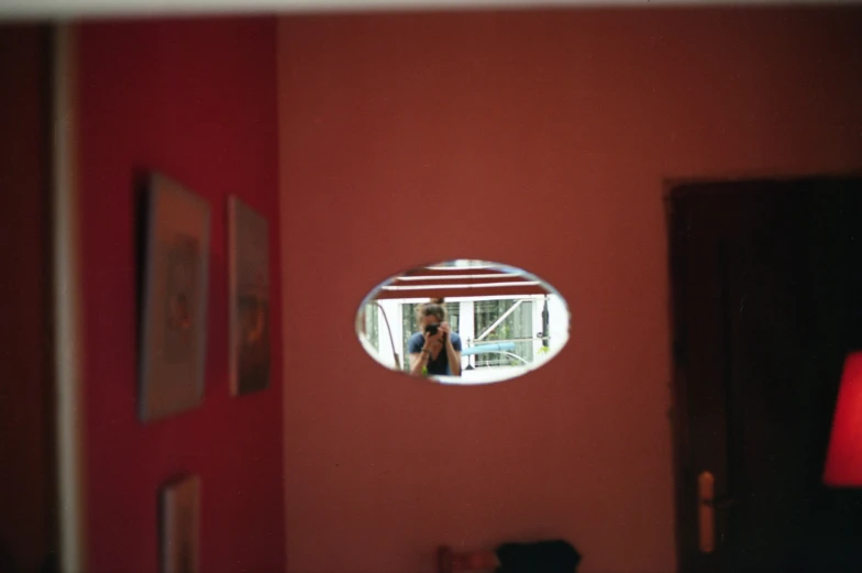 a mirror is shown with the reflection of a woman in it