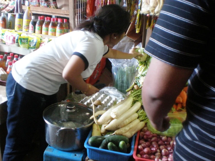 a person is selecting fresh fruits and vegetables