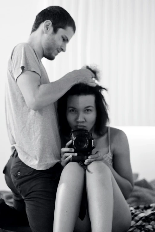 man helping a woman get her hair styled