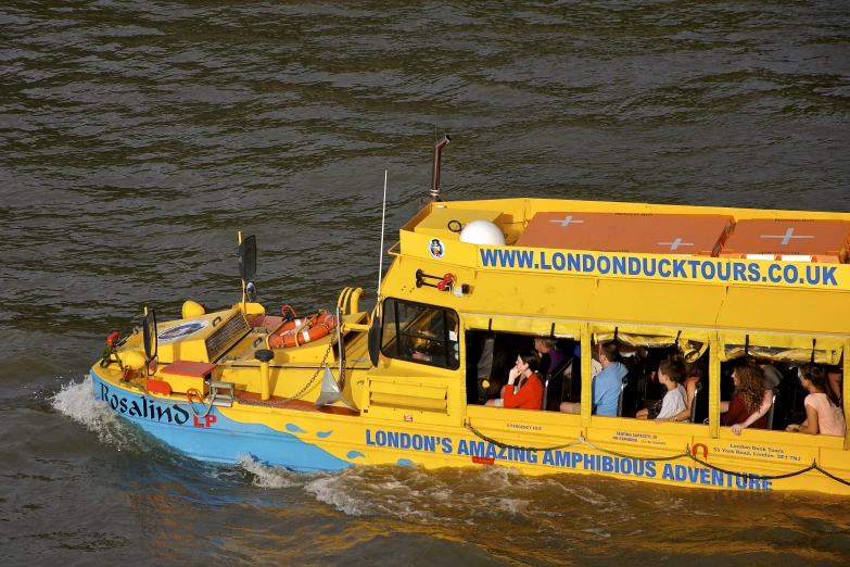 a yellow boat with people in it on a lake