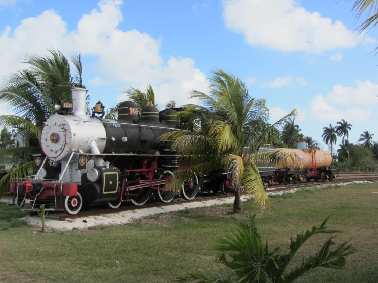 old train on a railroad track near trees