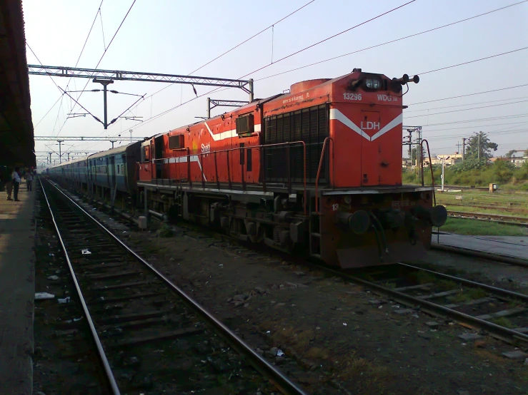 a train driving down tracks in an empty field