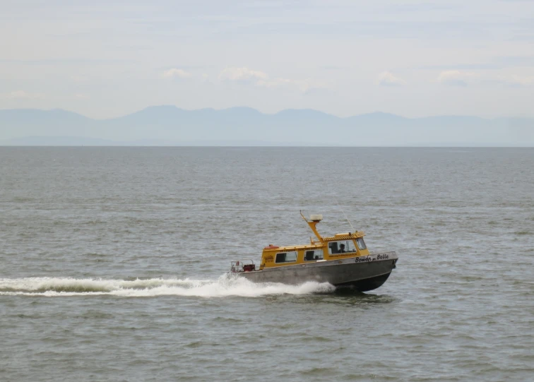 an ocean boat is speeding along the ocean