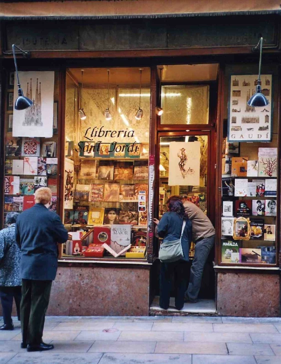 people browsing items inside a storefront window