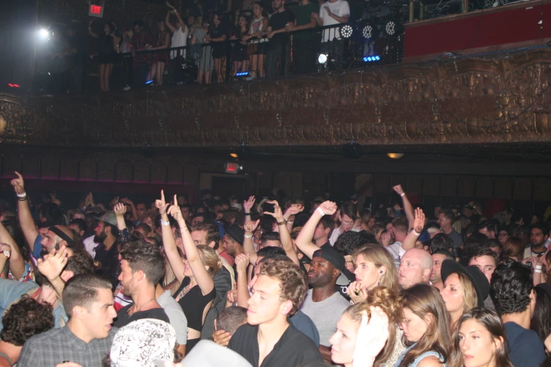 a crowd of people at a concert in front of the audience