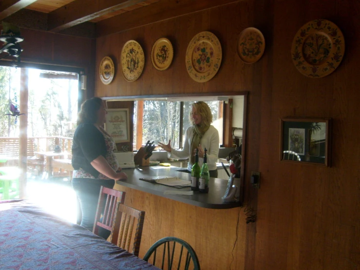 a woman is making drinks at the bar