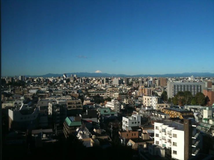 a cityscape with a hill in the distance