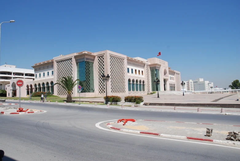 a large building is standing near a stop sign