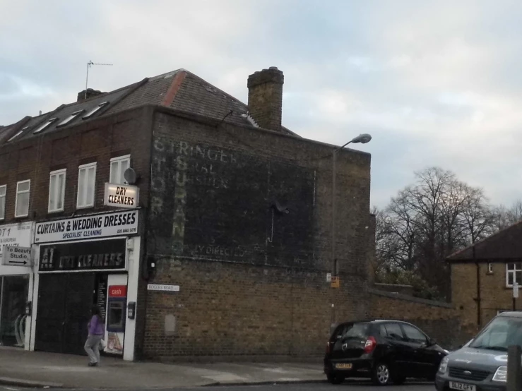 a brown brick building next to cars parked on the street