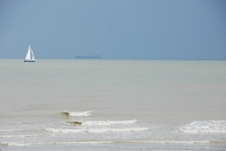 a sail boat in the middle of a body of water