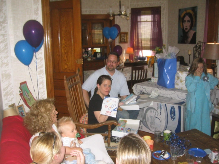 a group of people with presents and party balloons