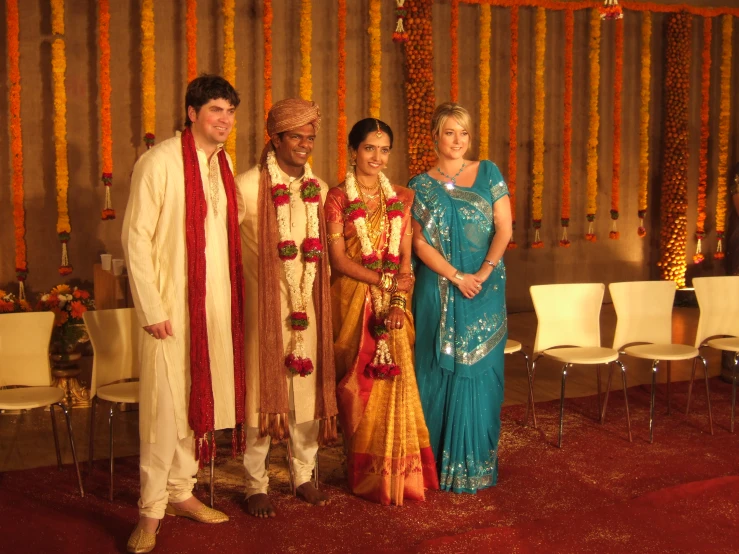 the two couples pose for the camera with each other