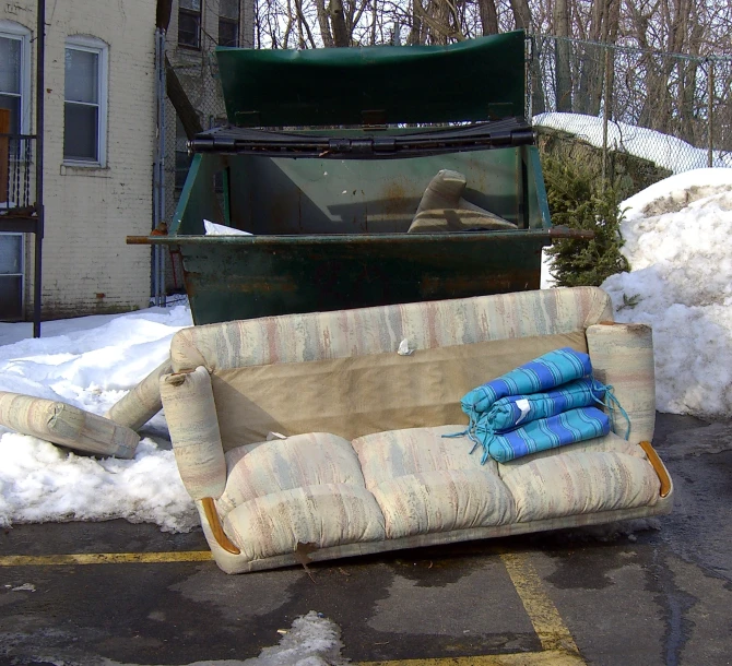 couch and pillows on the ground in front of snow