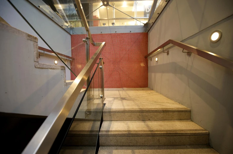 a staircase with red walls and lights is shown