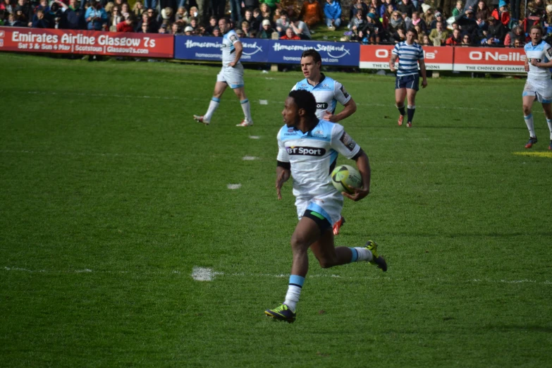 a player runs to the ball and looks forward