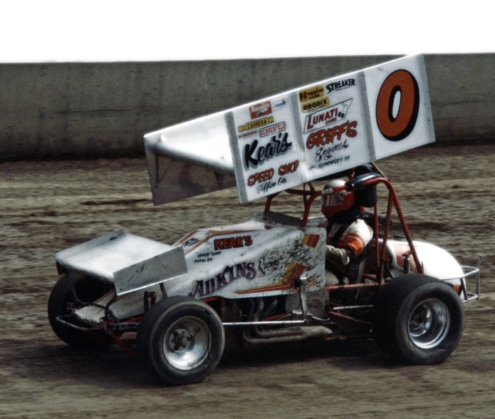 a dirt racing vehicle going fast on the track