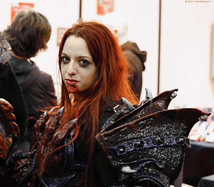 a woman dressed in armor posing for a picture