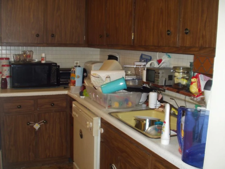 a kitchen with wood cabinets and tiled counter tops