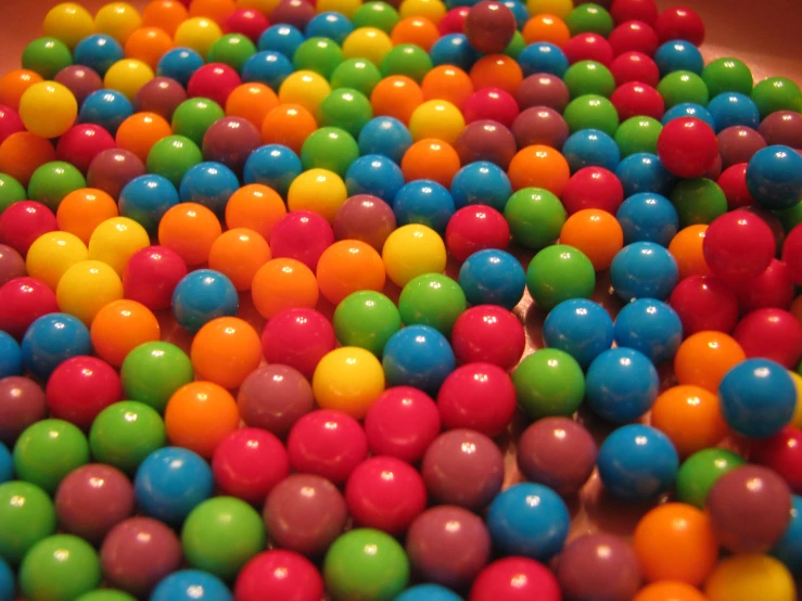 a large pile of colorful balls that is on display