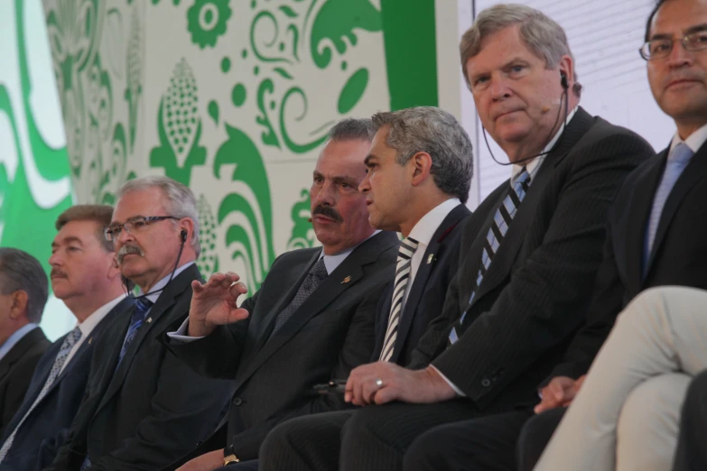 the men are all sitting down in business attire