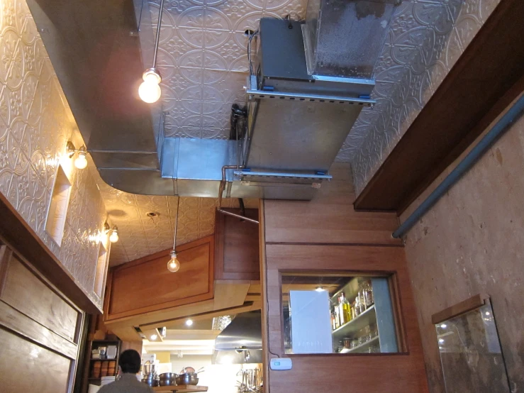 a commercial kitchen with stainless steel overhead lights