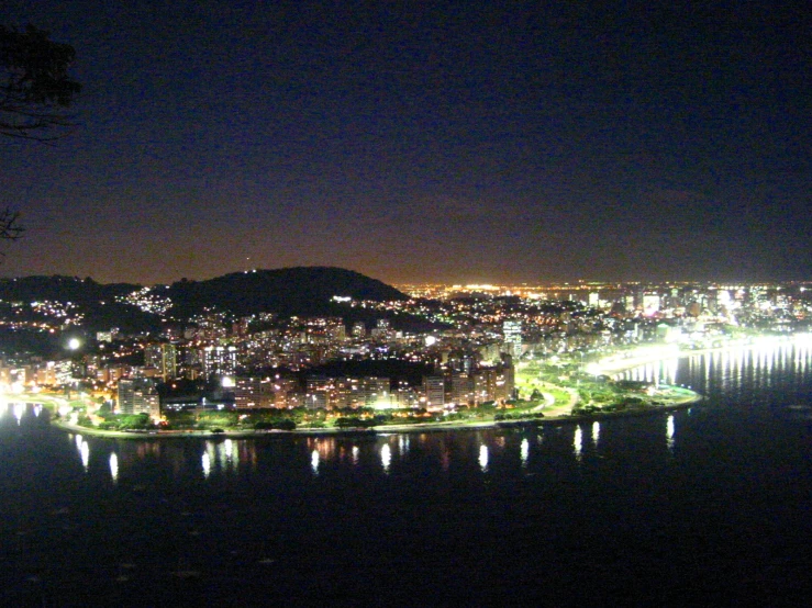 a city lit up at night over a large body of water