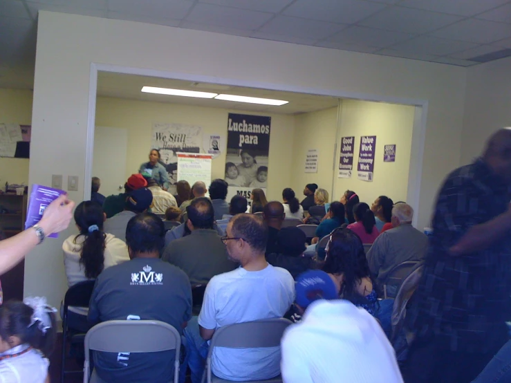 an audience of people in a large office building