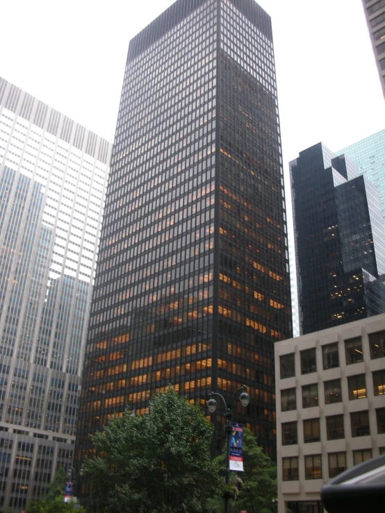 a very large glass building surrounded by other buildings