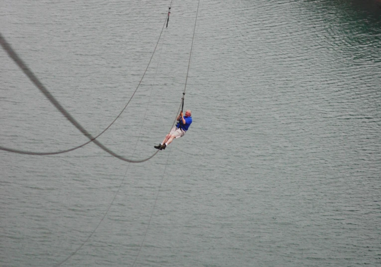 a man with a paraglider in his hand is holding on to the line