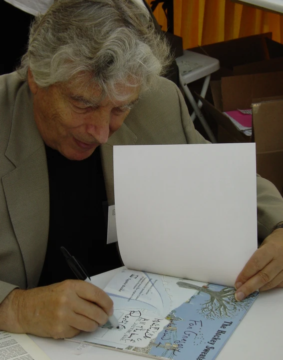 a person holding papers over a white table