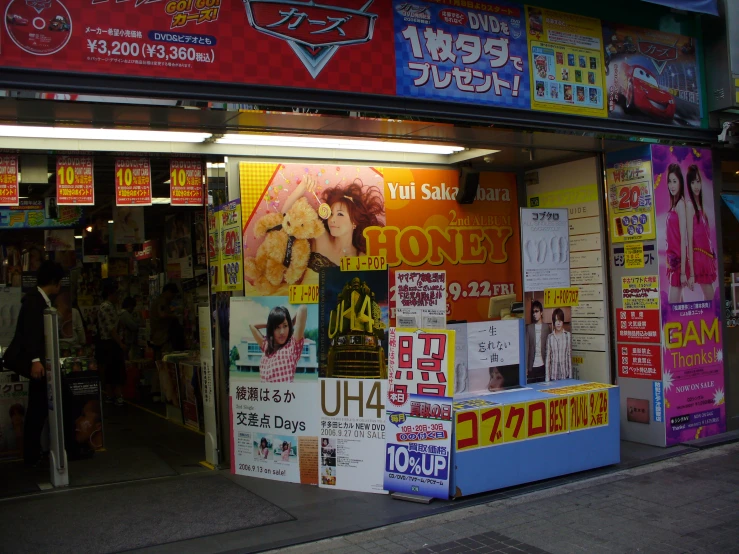 a shop front with many foreign signs hanging from the windows