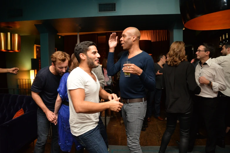 a group of people are standing in front of a bar