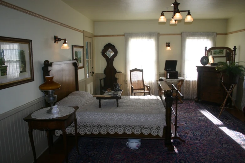 the room has a large bed and many chairs