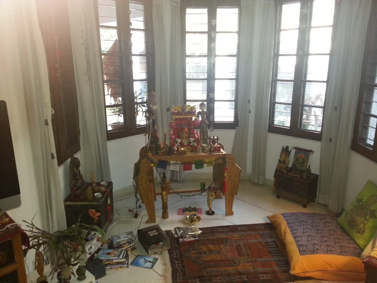 a sitting room with wooden furniture and windows