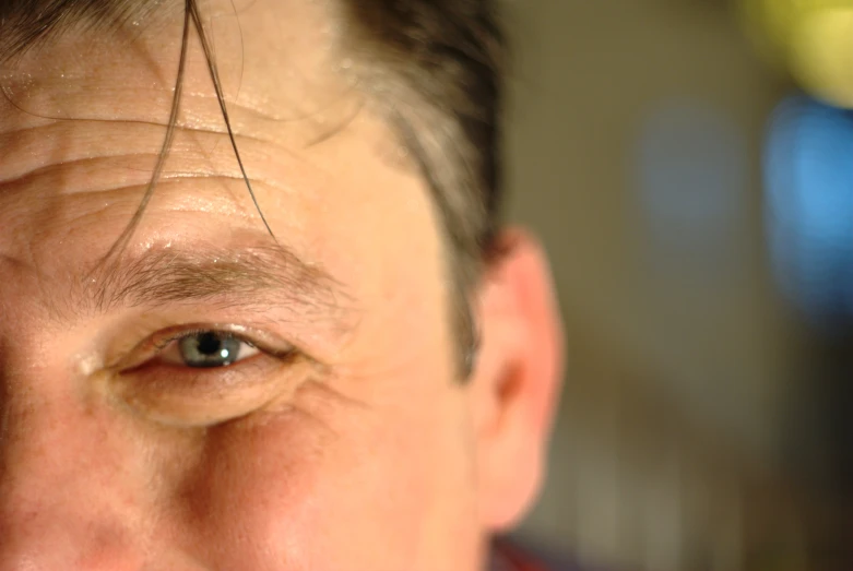 an older man with dark hair has eyes wide open