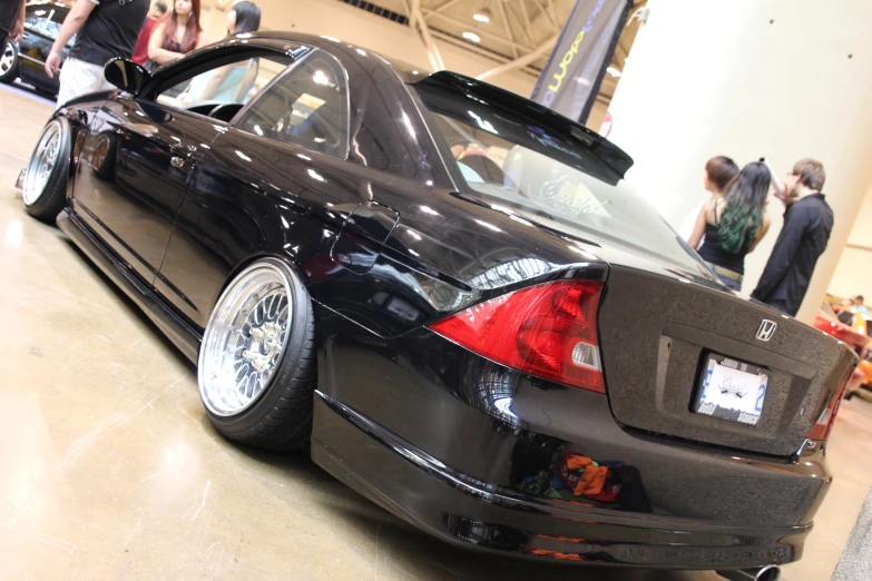 a black car is on display in a museum