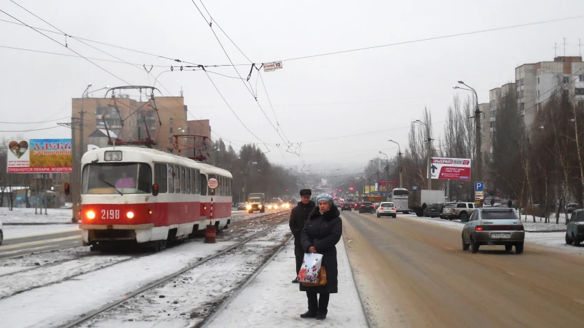 a couple of people standing by the side of a road