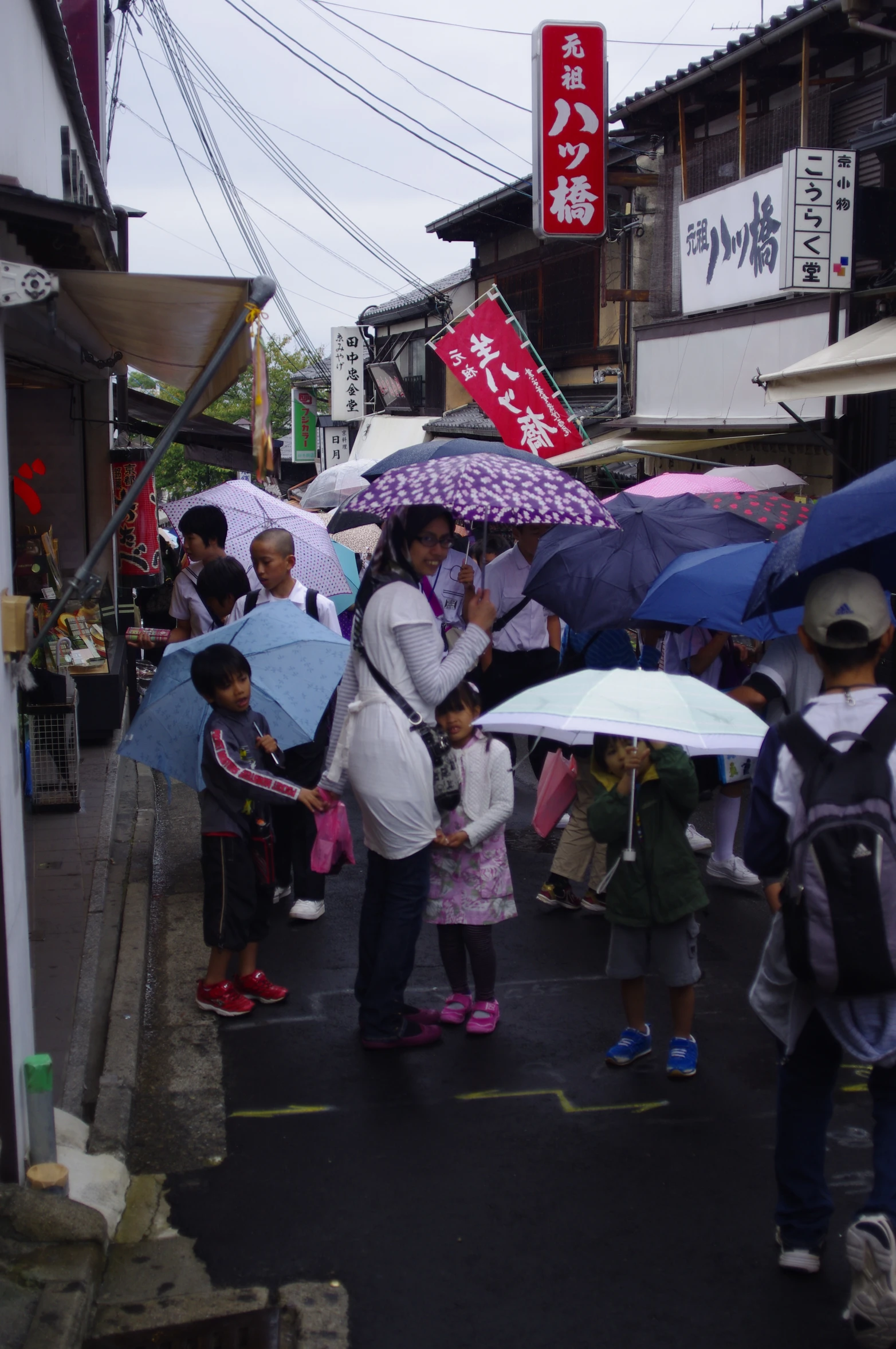 people are in the rain with umbrellas