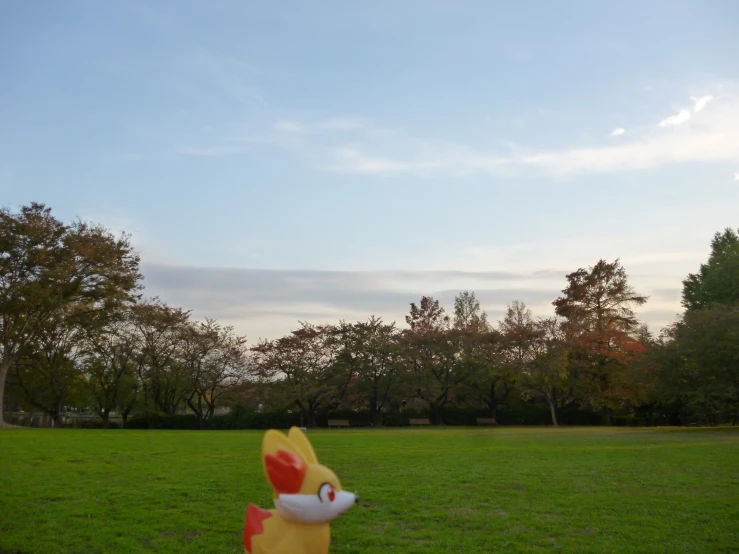 an inflatable animal statue that is laying on the grass