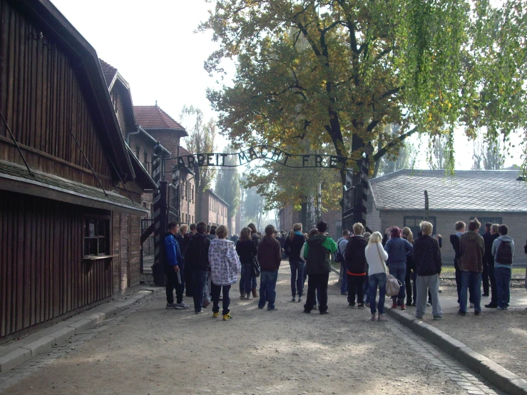 people walking down the street in a village