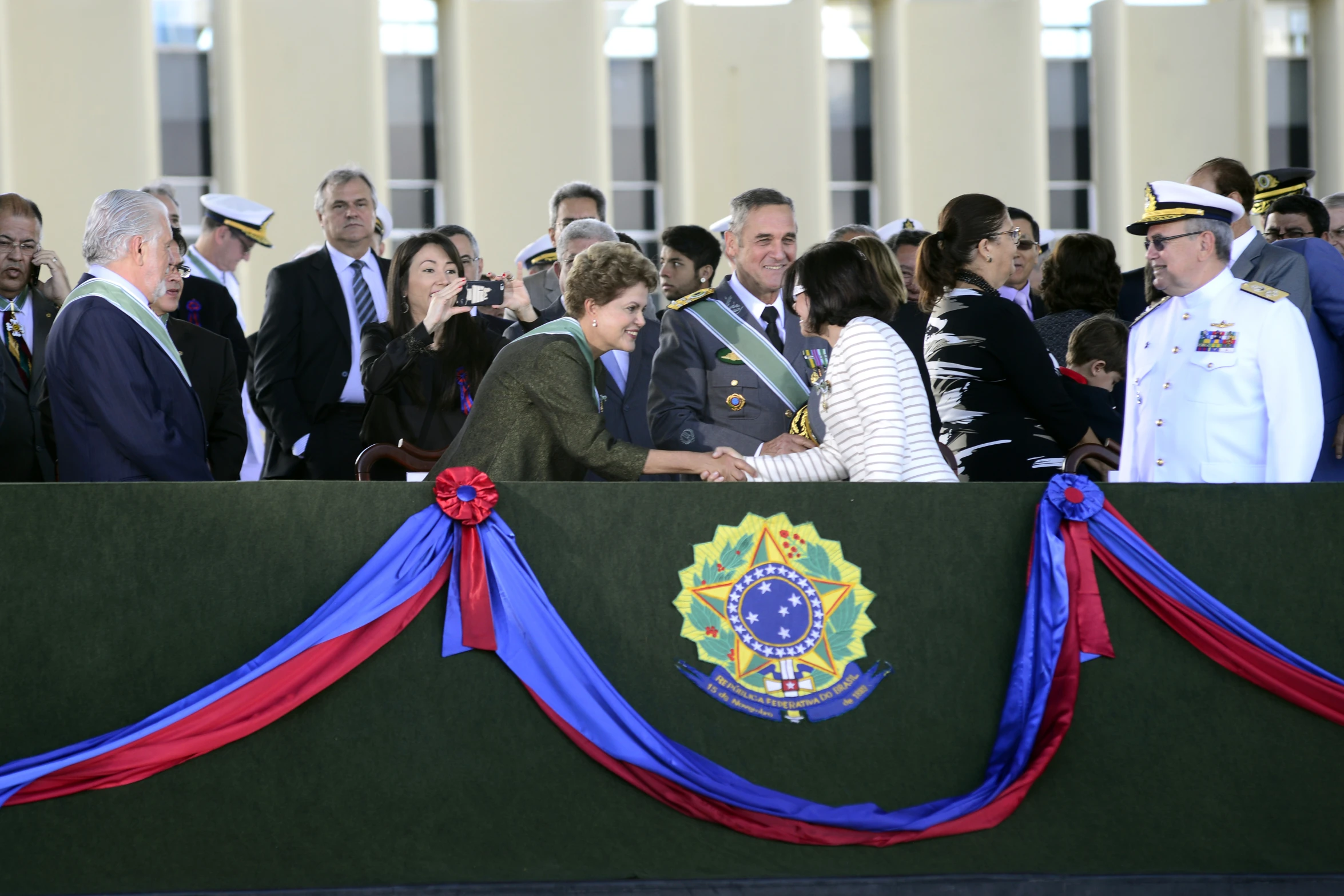 the military man and women are shaking hands at an event