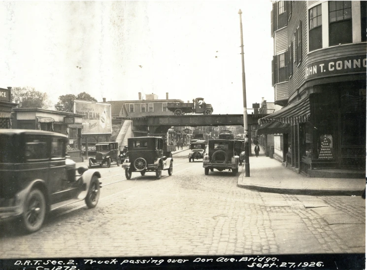 several antique trucks driving down the street