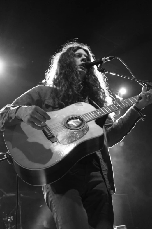 a man that is standing up with a guitar