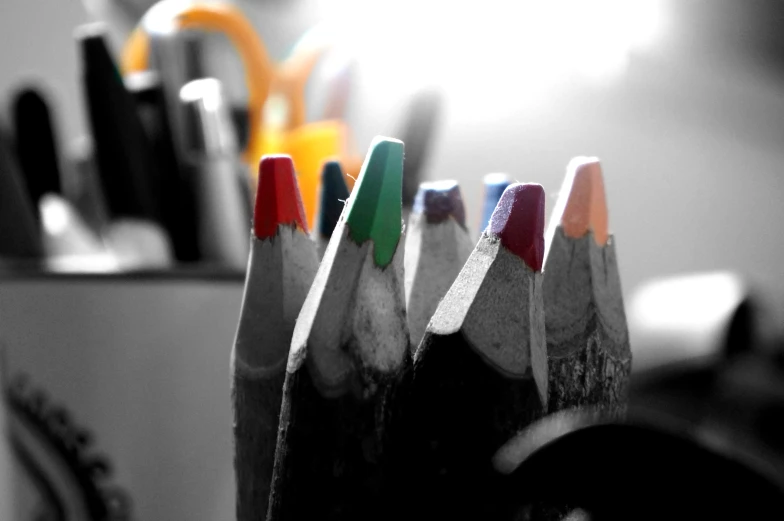 pencils in a row lined up with other pens