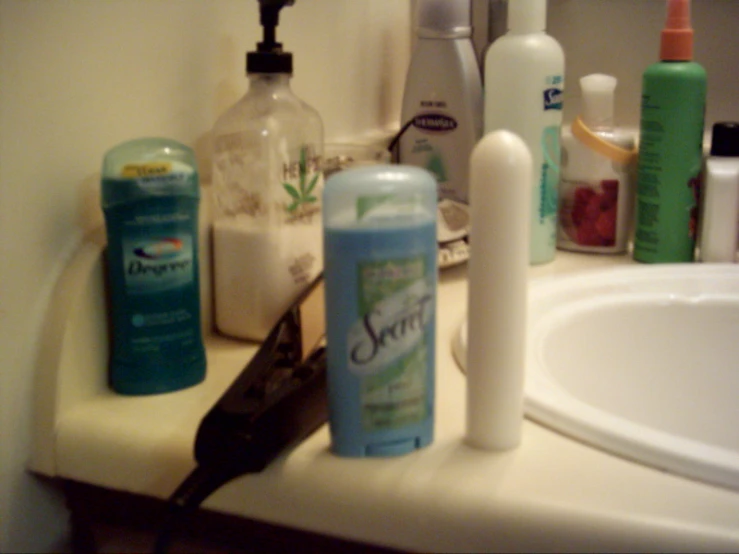 an assortment of groom products on counter next to sink