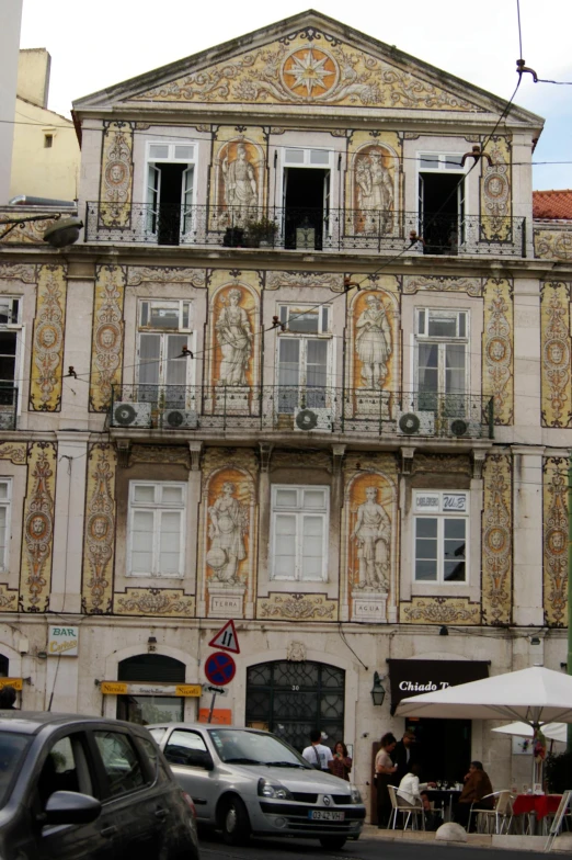 a tall white building with a clock on it's front