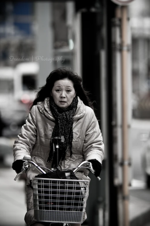 black and white po of a woman on a bike