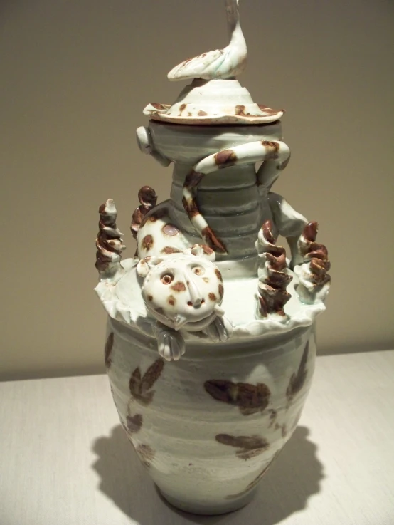 a close up of an artistically designed ceramic vase