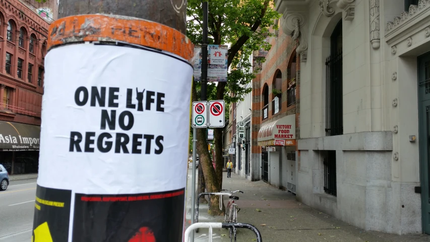 a one life no regents sign is posted on the post